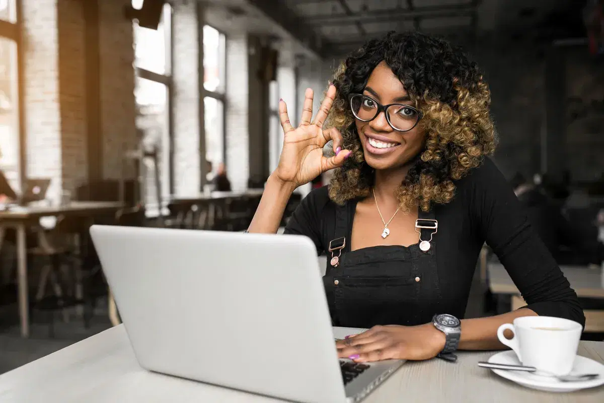 Smiling business owner working on her laptop